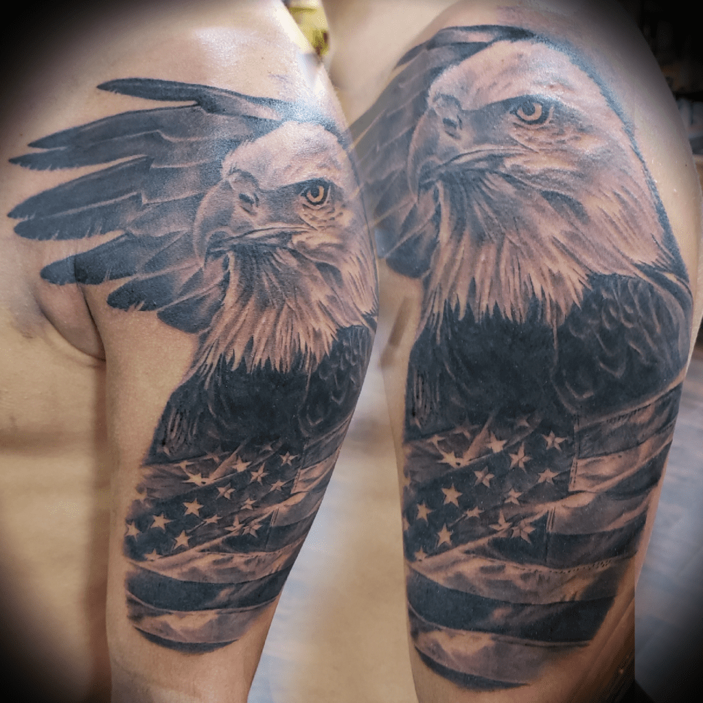 Black and grey realism tattoo of eagle and American flag